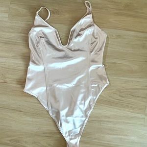 Champagne bodysuit from “Out from under” at Urban Outfitters. Size small.
